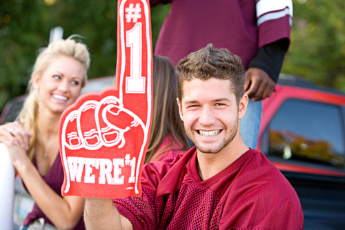 man holding up foam finger at tailgate